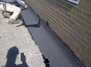 installation of flashing modified cap sheet in hot asphalt